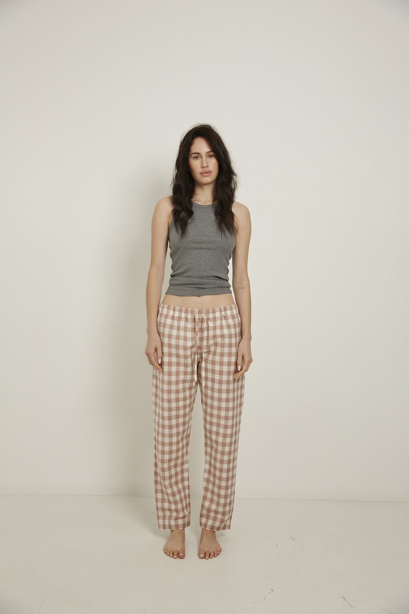 Women’s pyjama pant.  Made from an organic cotton and linen blend, in a pink and white check.  These pants feature an elasticated waistband with a drawstring for comfort.